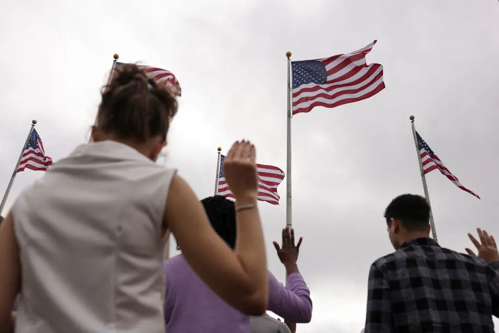 People reciting an oath during a naturalization ceremony at Liberty State Park in Jersey City, N.J.Credit...Kent J. Edwards/Reuters