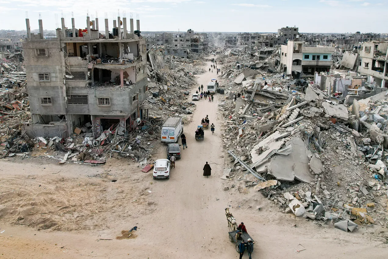 Palestinians walk past the rubble in Rafah on Jan. 20, 2025. Photo by AFP via Getty Images