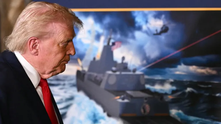 Donald Trump leaves the unveiling ceremony for the Navy's new 