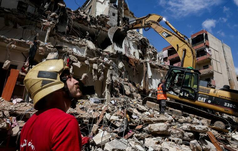 Rescuers assisted by heavy machinery work at the site of an Israeli strike carried out on Wednesday, in the southern suburbs of Beirut, Lebanon, today.