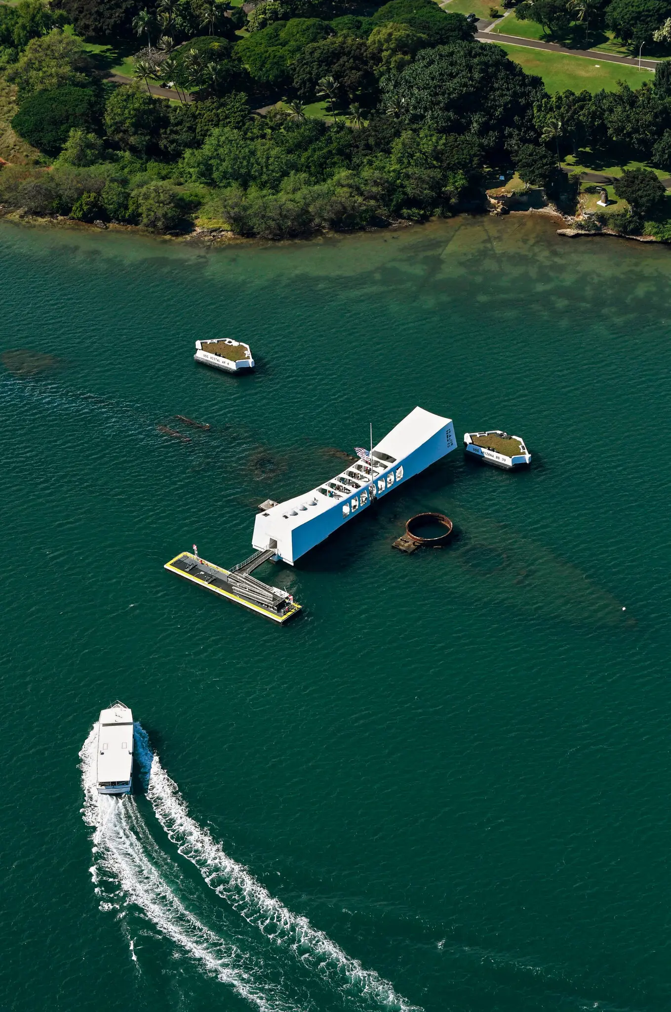 The memorial above the sunken battleship USS Arizona in Hawaii in 2016. Kash Patel, the F.B.I. director, was accompanied by Navy SEALs on a “V.I.P. Snorkel” over the site that holds the remains of 1,100 Navy sailors and Marines who died at Pearl Harbor.Credit...Kyodo News, via Associated Press