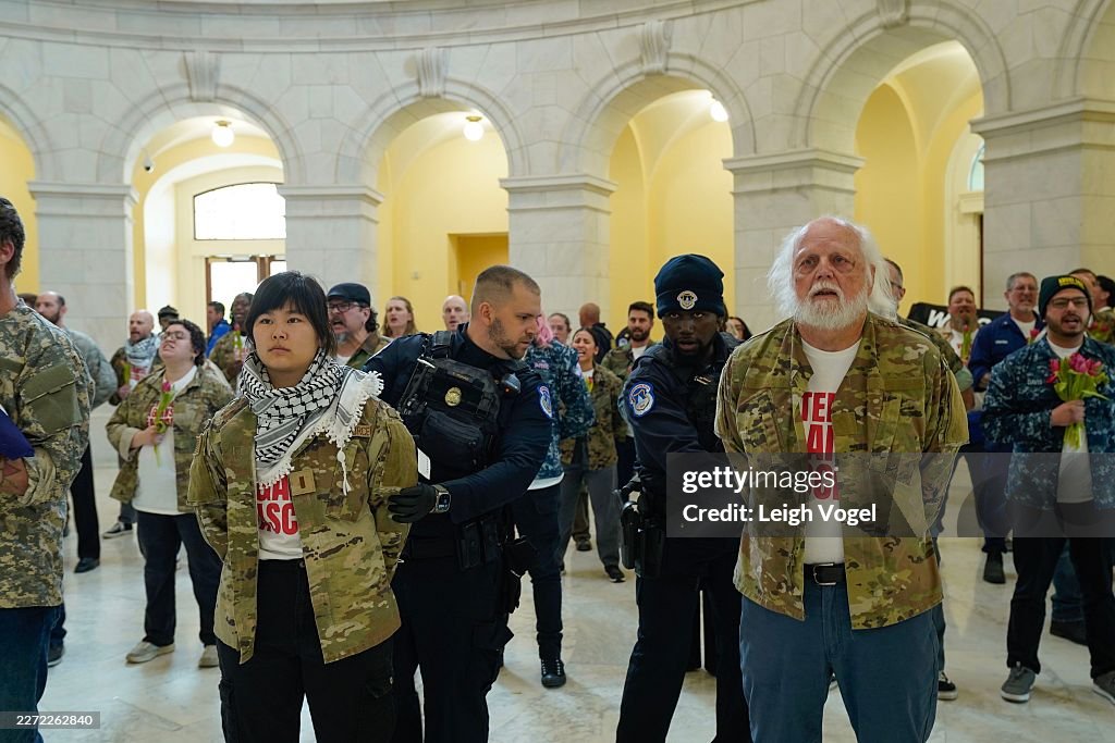 Veterans, military family members, and supporters are detained by U.S. Capitol Police officers during an demonstration in the Cannon House Office Building on Capitol Hill calling upon the Trump administration to end the war on Iran on April 20, 2026 in Washington, DC. (Photo by Leigh Vogel/Getty Images for About Face: Veterans Against The War)