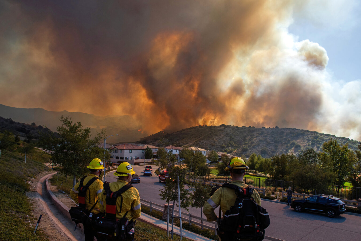 Firefighters monitor the Sandy Fire as it burns close to a residential area on Monday in Simi Valley, Calif. Credit: Apu Gomes/AFP via Getty Images