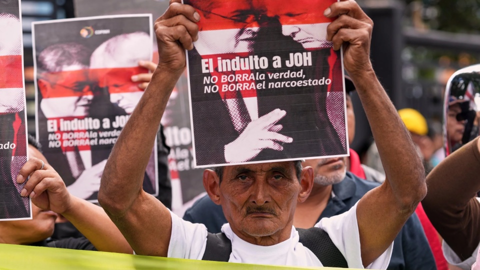 Farmers protest against President Donald Trump's pardon of Honduras' former President Juan Orlando Hernández in Tegucigalpa, Honduras, Dec. 4, 2025. The sign reads: 'The pardon of JOH (Juan Orlando Hernández) does not erase the truth, does not erase the narcostate.' | Moises Castillo / AP