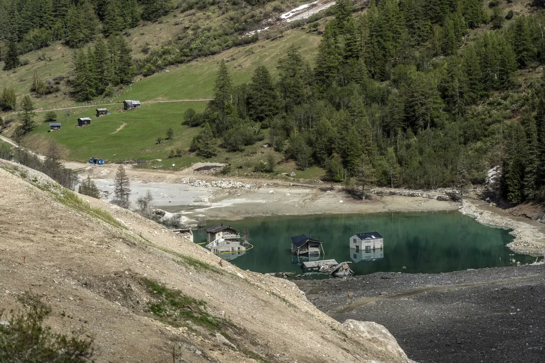 A few of the Blatten's houses are still standing, flooded by a new lake that formed in the valley.Photographer: Jose Cendon/Bloomberg