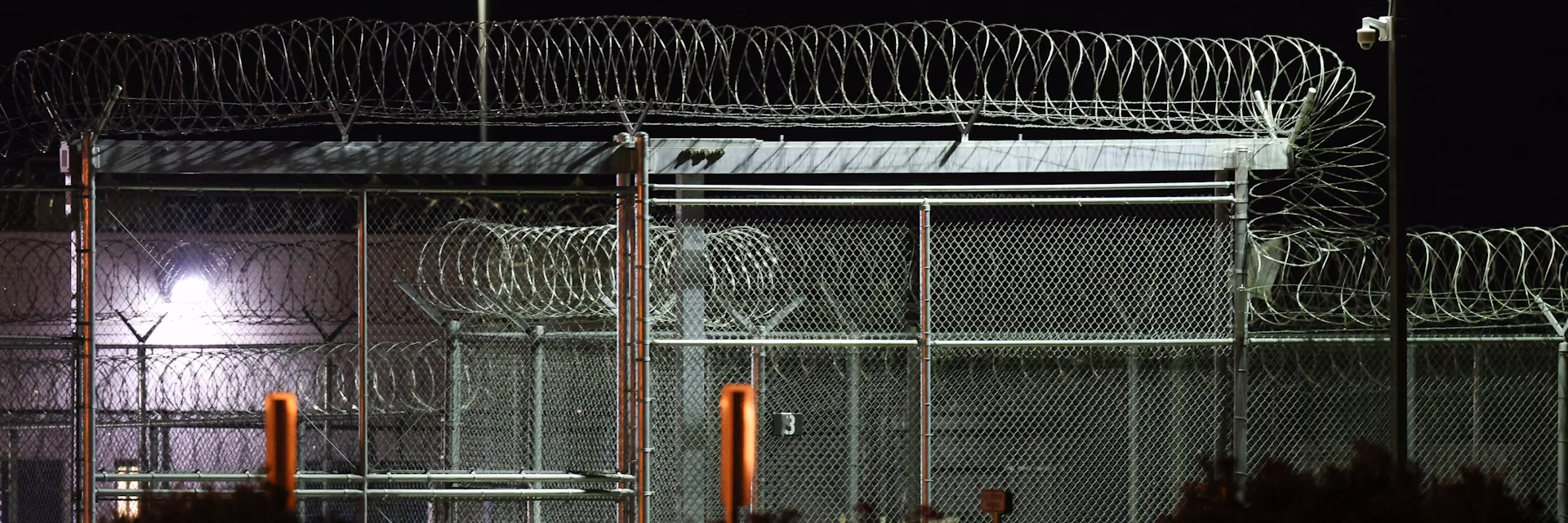 Barbed wire surrounds the GEO Group ICE detention facility in Adelanto, Calif. on July 10, 2025. Patrick T. Fallon/AFP via Getty Images
