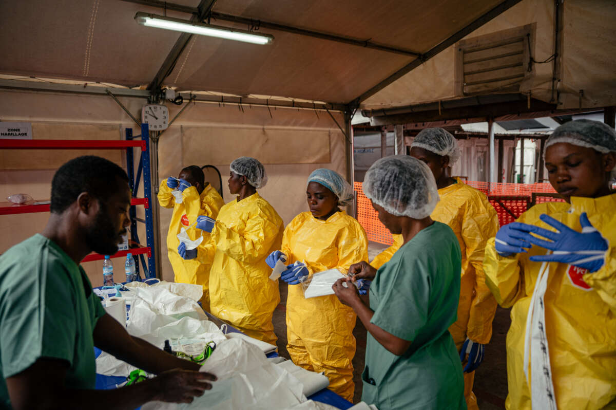 Health care workers put on personal protective equipment before going to examine patients at the Ebola Treatment Center in Munigi, Democratic Republic of the Congo, on June 2, 2026.Jospin Mwisha / AFP via Getty Images