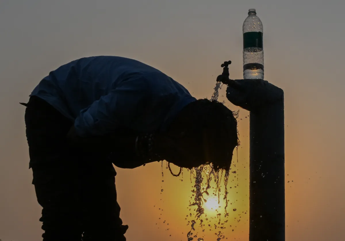 A man cools himself with water during hot weather in Allahabad, India.Photographer: Ritesh Shukla/Getty Images