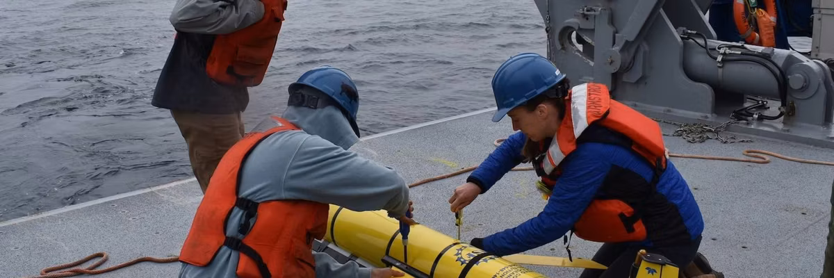 Researchers prepare to deploy a glider instrument into the ocean. (Photo by Rebecca Travis/Woods Hole Oceanographic Institution)