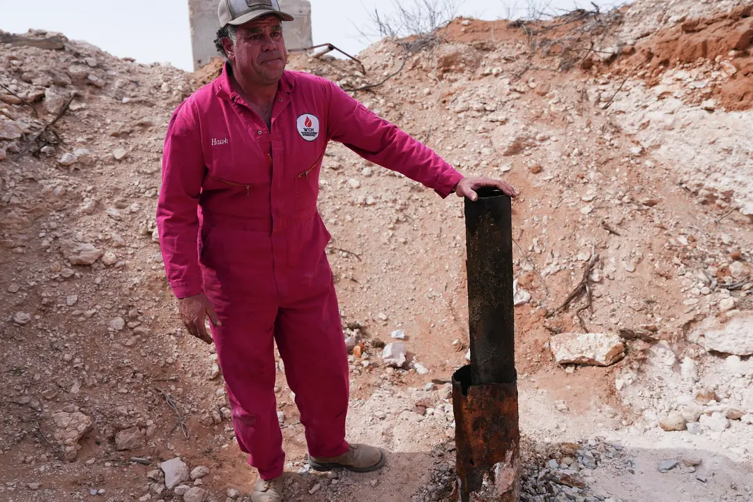Hawk Dunlap puts his hand over an abandon well as he shakes it to show how loose it is on Antina Ranch in West Texas on Wednesday, March 6, 2024.Elizabeth Conley/Houston Chronicle