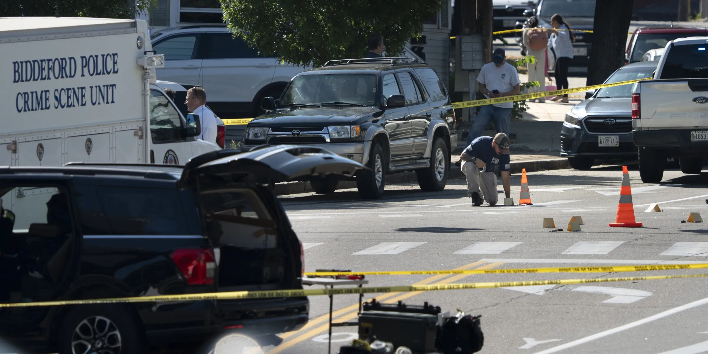 An FBI official places an evidence card in Biddeford, Maine, where a 25-year-old man was shot and killed by an ICE officer on July 13, 2026. Photo: Gregory Rec/Portland Press Herald via Getty Images