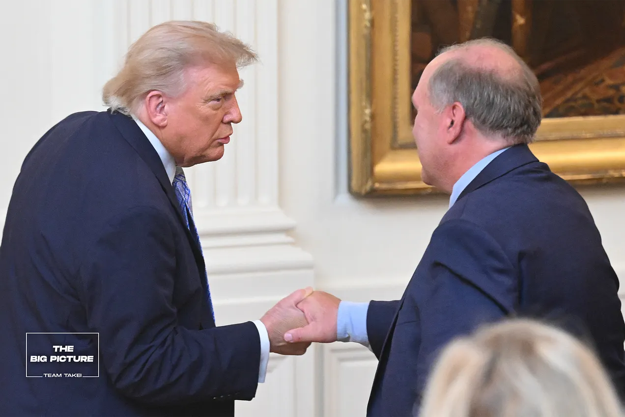 U.S. President Donald Trump shakes hands with journalist John Solomon. Photo by Saul Loeb/Pool - Getty Images.