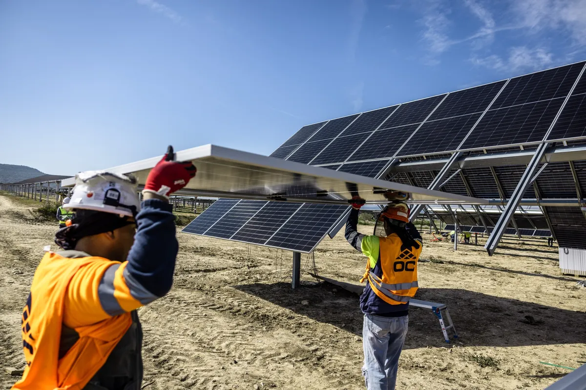 Workers install solar panels at the Fuendetodos II solar park, operated by Zelestra Corp. SA, in Villanueva de Huerva, near Zaragoza, Spain, on Wednesday, March 25, 2026. Renewables are helping cushion the blow of higher oil and gas prices in Europe.Photographer: Angel Garcia/Bloomberg