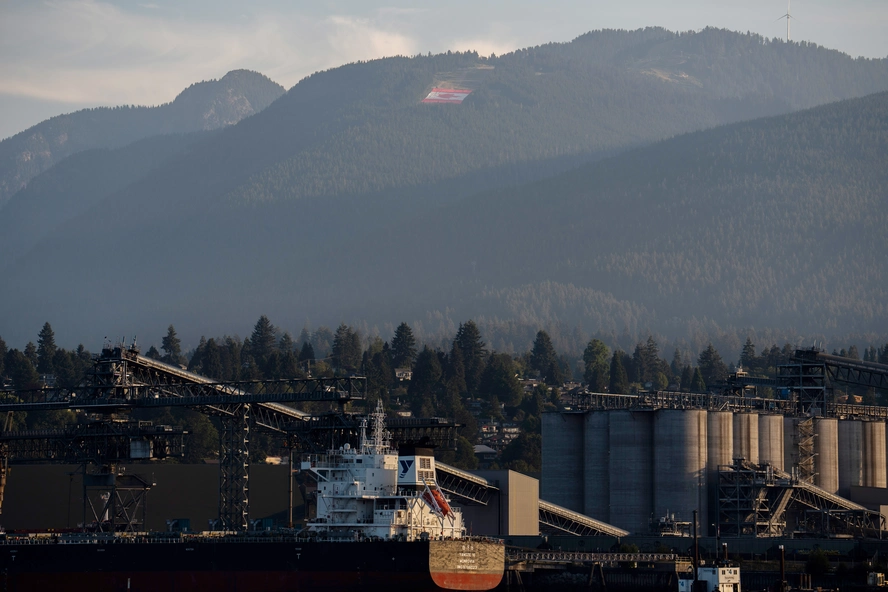 A Canadian flag on Grouse Mountain above the Port of Vancouver in Vancouver, Canada, on July 22, 2026. | Paige Taylor White/Bloomberg via Getty Images