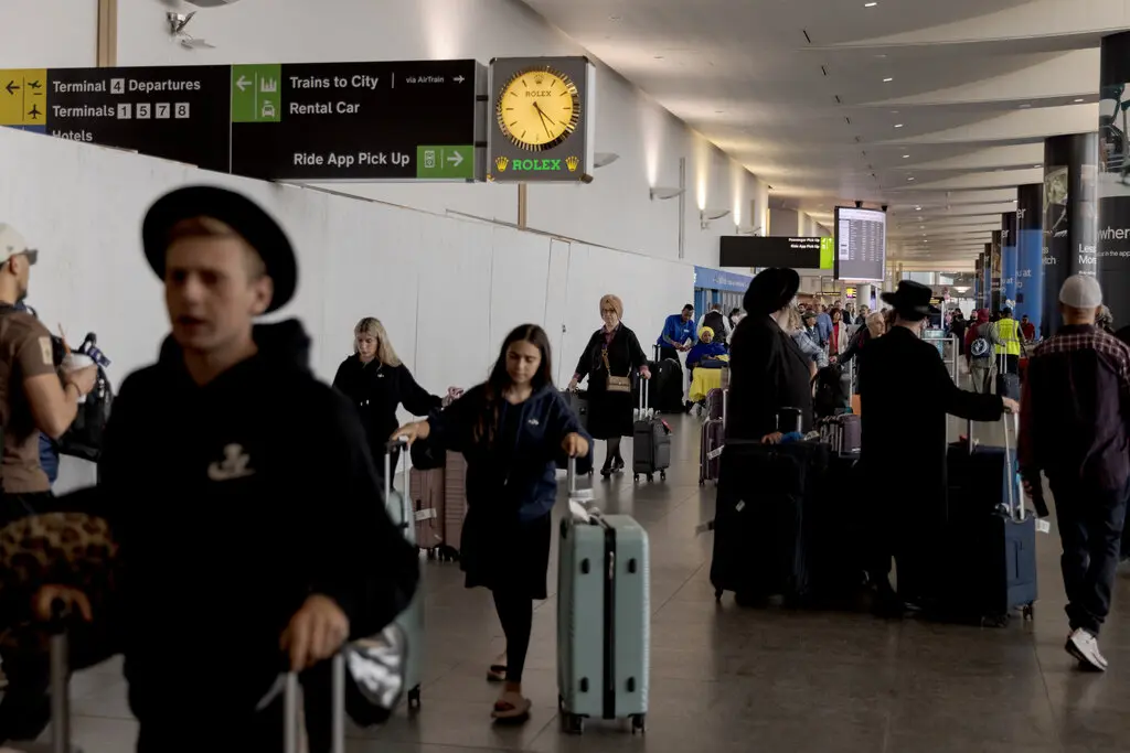 Travelers arriving from international flights outside the U.S. Customs and Border Protection exit at Kennedy International Airport in New York last year.Credit...Anna Watts for The New York Times