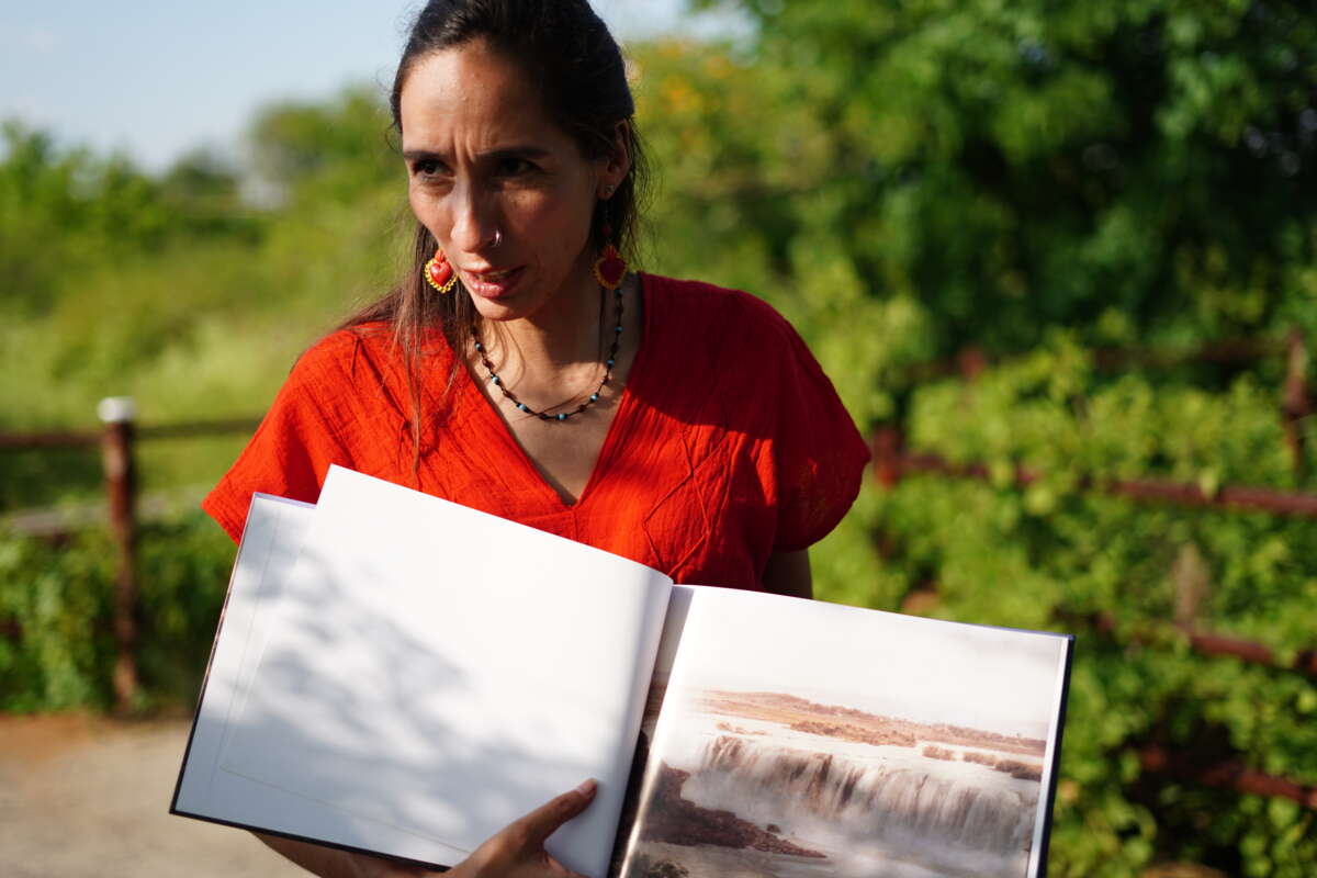 Atahualpa Sofía Enciso lives near the Santiago River and is a member of Salto de Vida, a collective that defends it. She holds a book showing what the river used to look like.Tamara Pearson