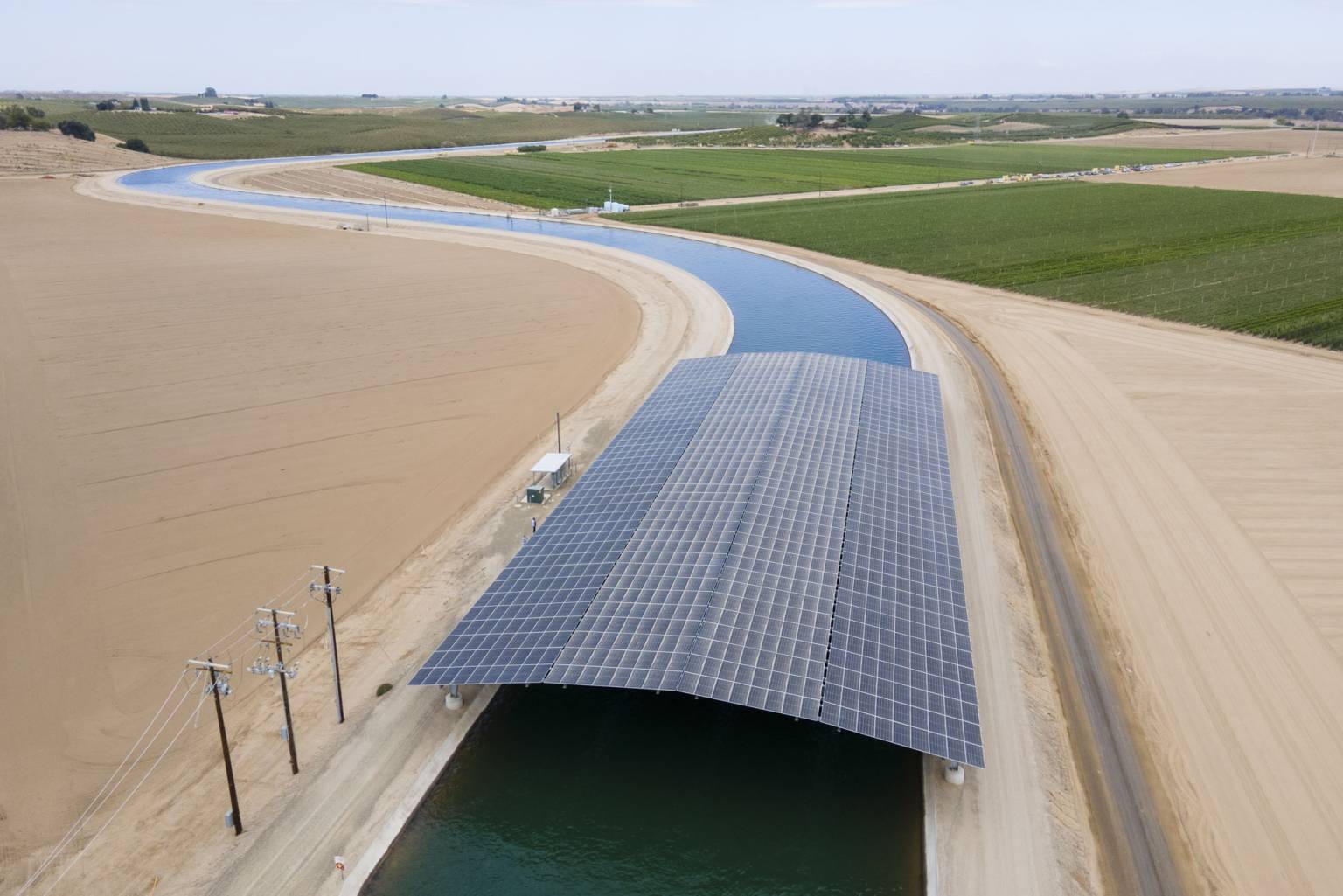Solar panels cover part of a Turlock Irrigation District canal as part of Project Nexus in Hickman, California, on Sept. 4, 2026. The pilot project is testing the use of solar panels over working irrigation canals to generate renewable energy. (Beth LaBerge/KQED)