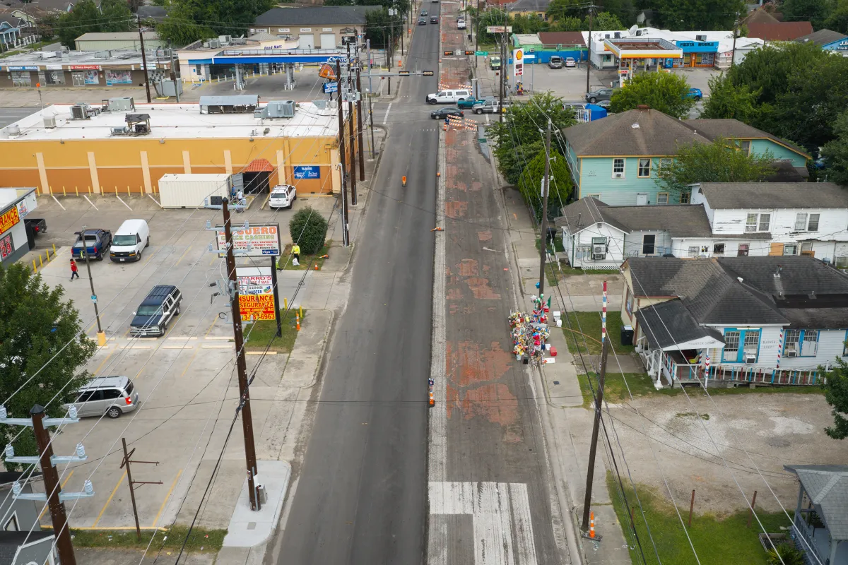 An aerial view of Canal Street in Houston, looking west, on July 12, 2026. Center right, opposite the strip mall, is a memorial to Lorenzo Salgado Araujo, who was was fatally shot by an immigration agent on July 7. Jon Shapley for The Texas Tribune