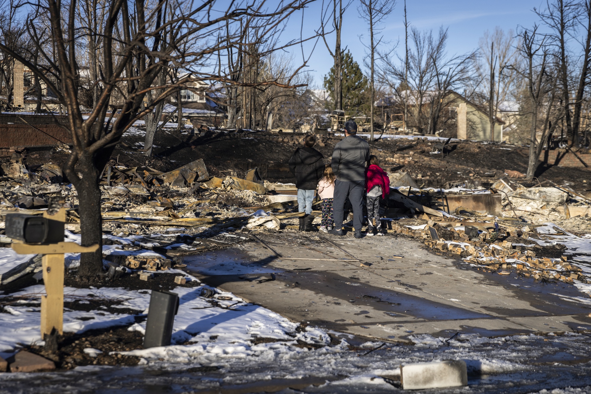 Residents survey remains of homes that were burned during the Marshall Fire in Superior, Colorado, in Boulder County, on Jan. 2, 2022.Photographer: Chet Strange/Bloomberg