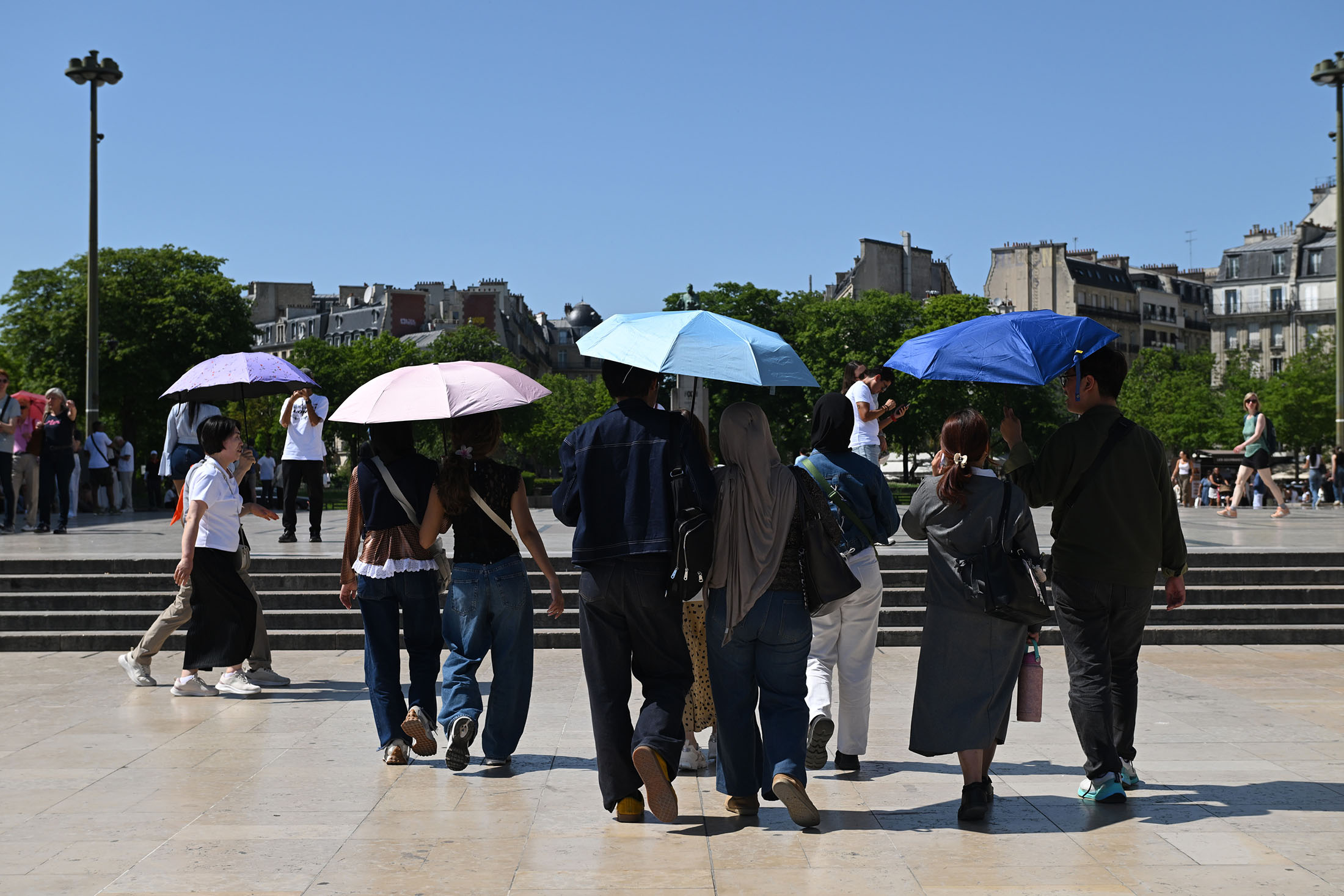 Visitors use umbrellas to shelter from the sun during high temperatures in central Paris, in May.Photographer: Benjamin Girette/Bloomberg Visitors use umbrellas to shelter from the sun during high temperatures in central Paris, in May.Photographer: Benjamin Girette/Bloomberg